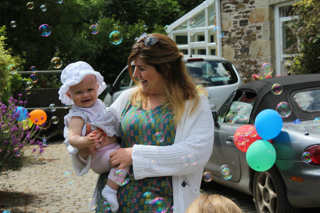 Lady holding child at naming ceremony party