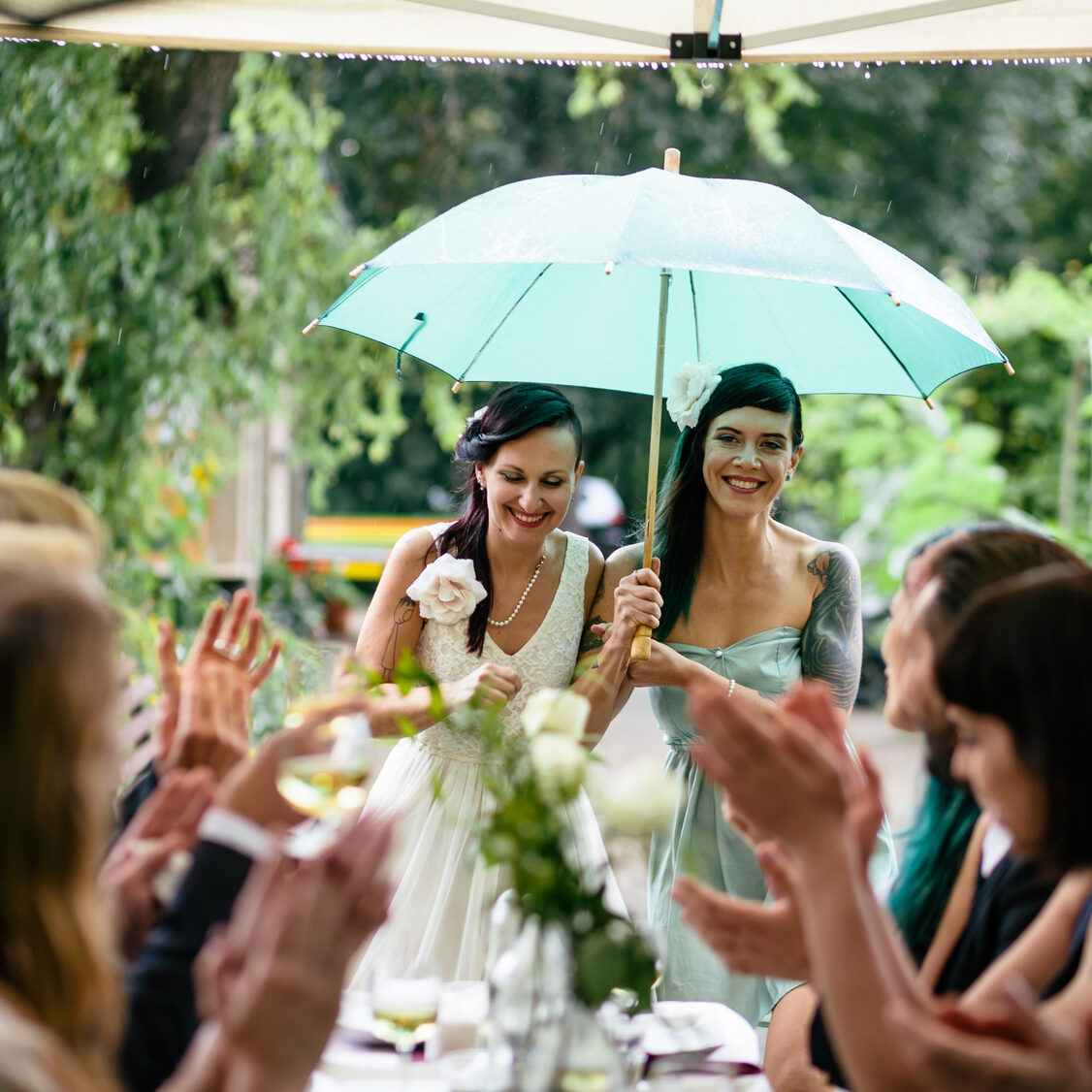 Lesbian Couple with umbrella during wedding reception
