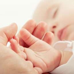 hand-sleeping-baby-mother-closeup-260nw-129290474