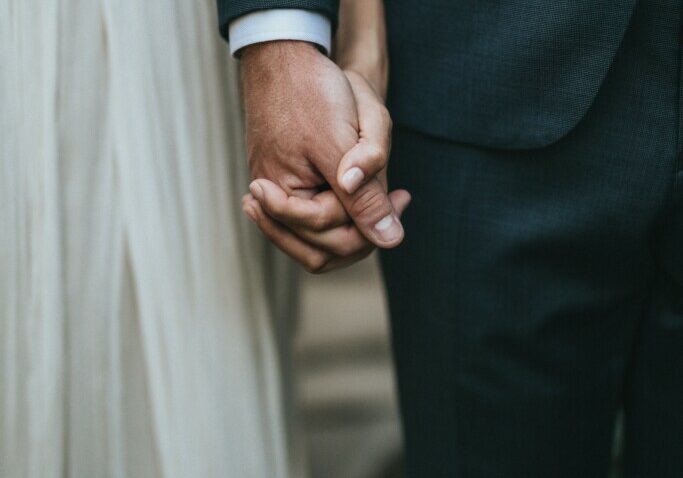 bridge and groom holding hands